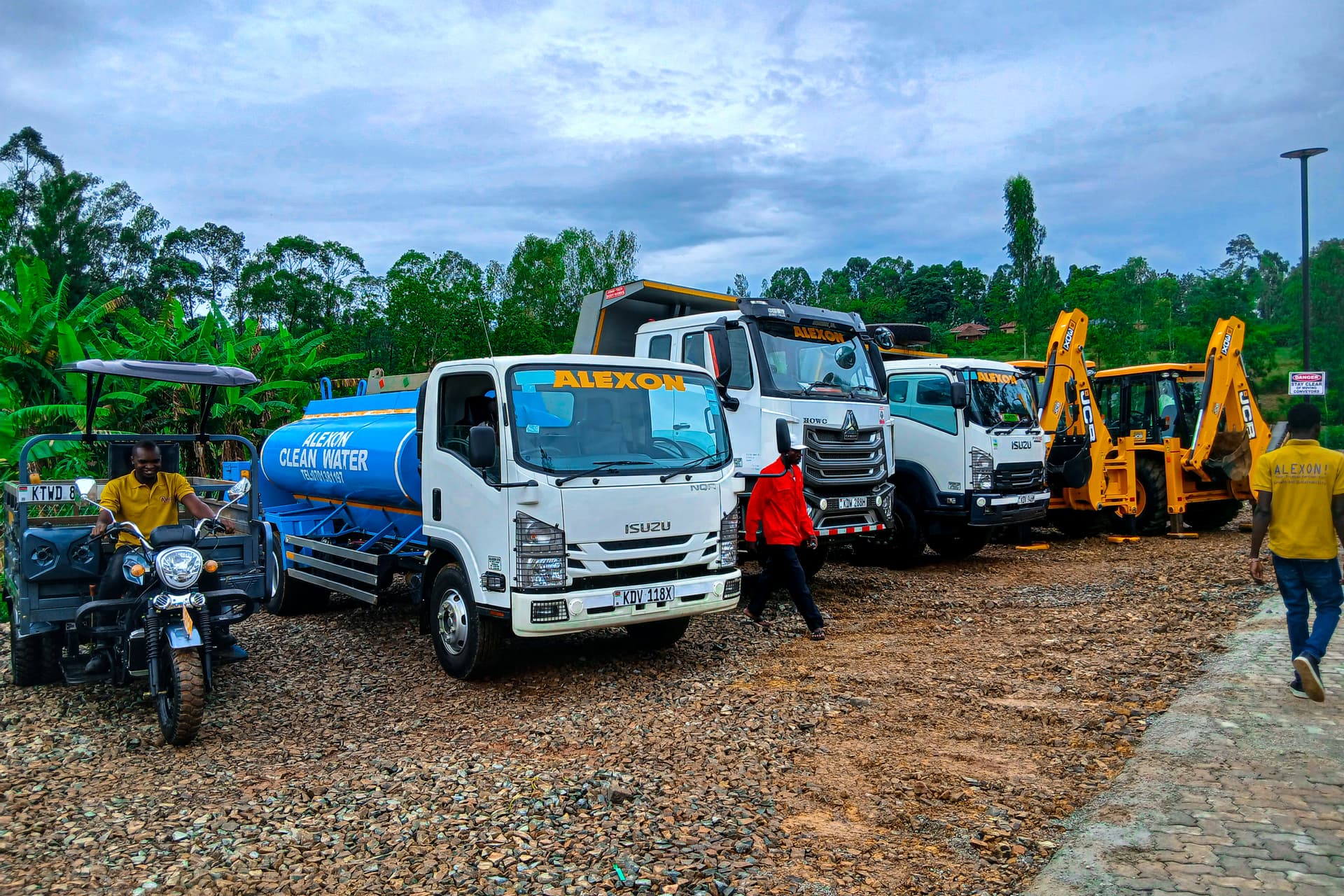 Alexon water bowser, tipper, lorry and two JCB backhoes lined up at the yard with the team